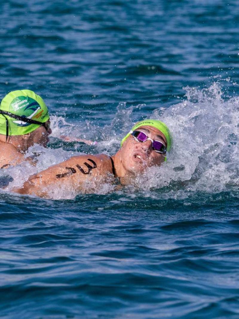 Two male swimmers in an open water competiion